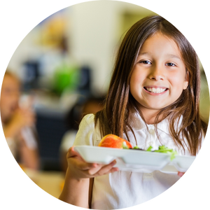 young girl holding lunch tray